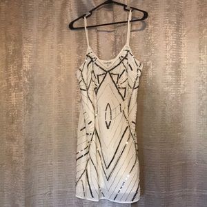 White dress with black and silver beading.